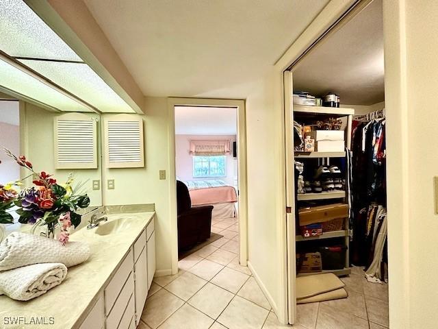 bathroom with tile patterned flooring and vanity