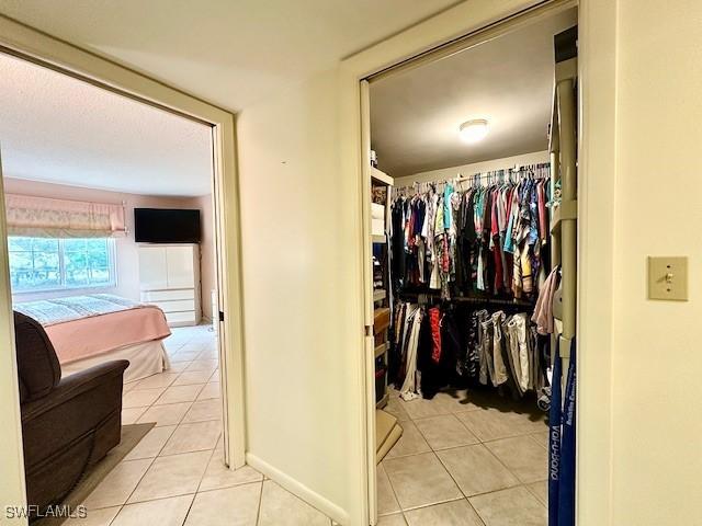 spacious closet featuring light tile patterned flooring