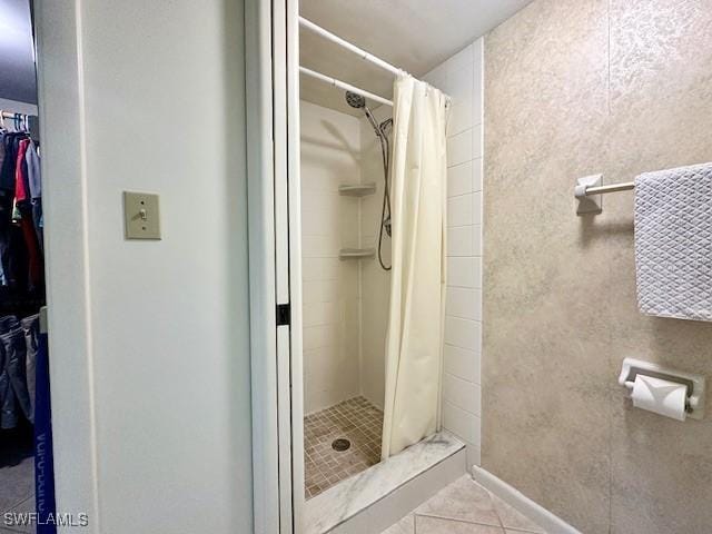 bathroom with tile patterned floors and a shower with curtain