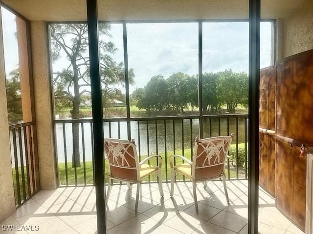 unfurnished sunroom featuring a water view