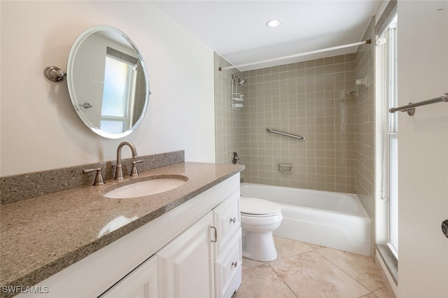 full bathroom featuring a wealth of natural light, tiled shower / bath combo, tile patterned floors, toilet, and vanity