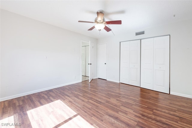355 Palm Dr Unit 1, Naples, FL 34112 - unfurnished bedroom with wood finished floors, baseboards, and a ceiling fan