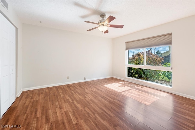 spare room with hardwood / wood-style flooring, ceiling fan, and a textured ceiling