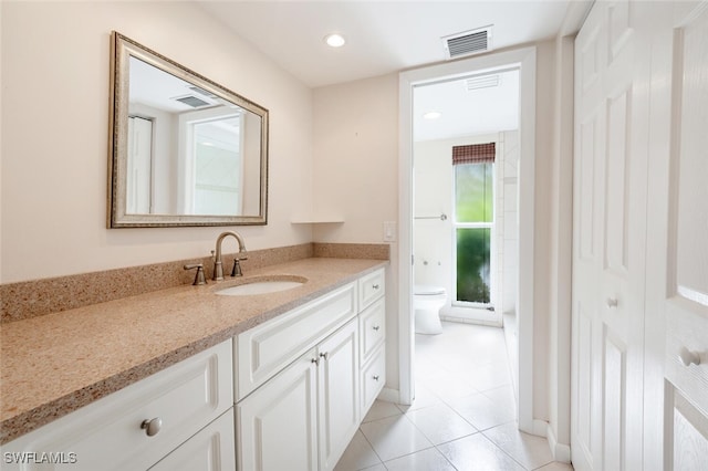 bathroom with tile patterned floors, vanity, and toilet