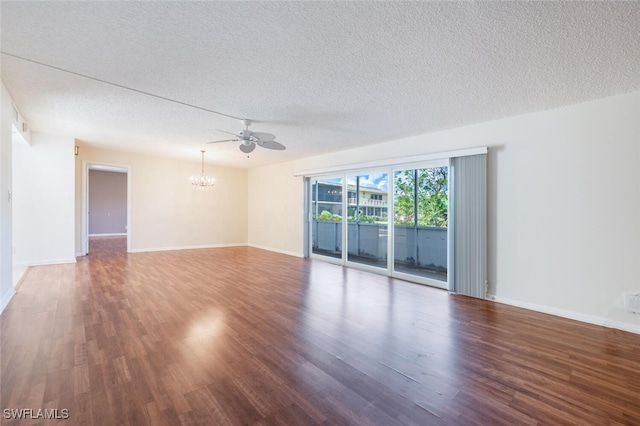 spare room with ceiling fan with notable chandelier, a textured ceiling, and dark hardwood / wood-style floors