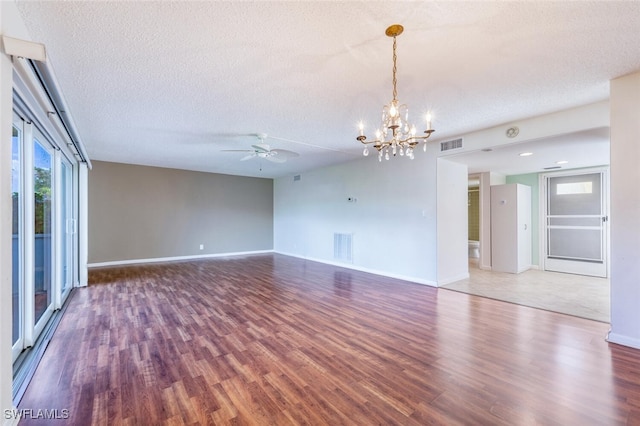 unfurnished room with ceiling fan with notable chandelier, hardwood / wood-style floors, and a textured ceiling