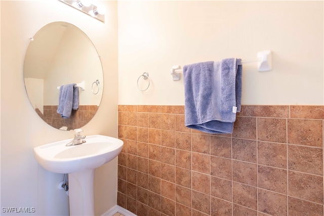 bathroom with tile walls