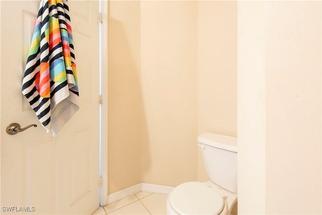 bathroom featuring toilet and tile patterned flooring