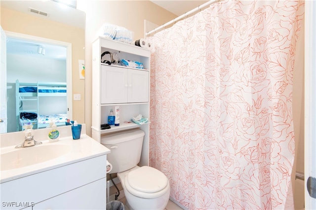 bathroom with vanity, a shower with curtain, and toilet