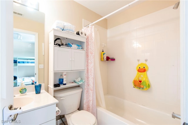 full bathroom with vanity, shower / bath combo, and toilet