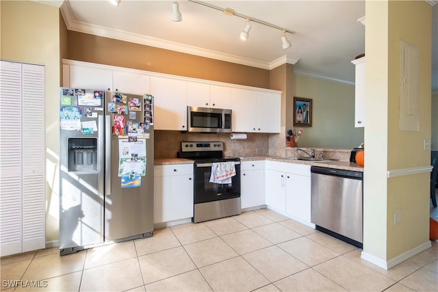 kitchen featuring ornamental molding, white cabinetry, stainless steel appliances, and light tile patterned flooring