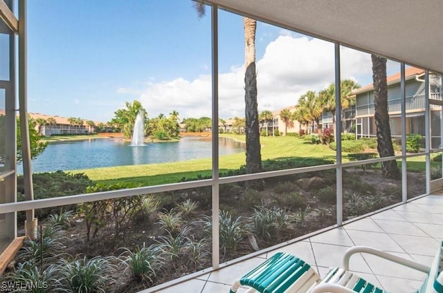 unfurnished sunroom with a water view