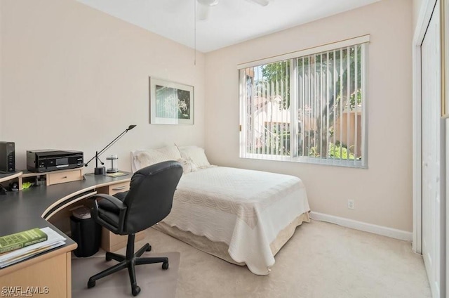 bedroom with ceiling fan, a closet, and light carpet