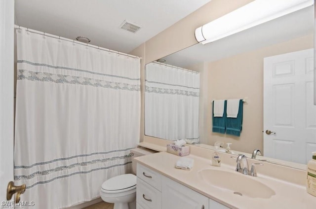 bathroom with toilet and vanity