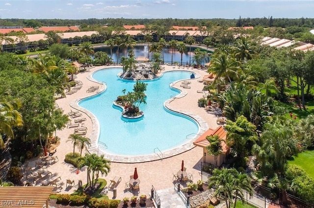 view of swimming pool with a patio and a water view