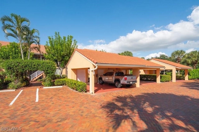 view of vehicle parking with a garage and a carport