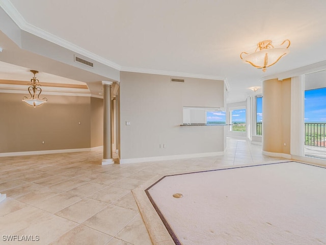 tiled spare room featuring decorative columns, crown molding, and a healthy amount of sunlight