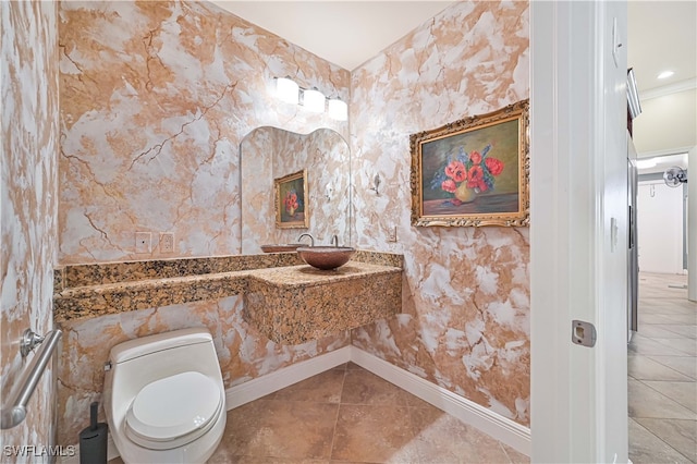 bathroom with ornamental molding, toilet, and tile patterned flooring