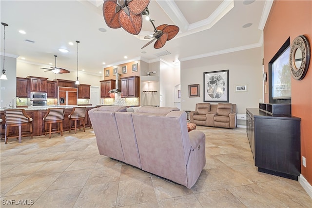 living room featuring ornamental molding and ceiling fan