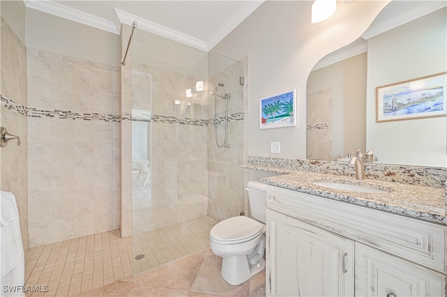 bathroom with toilet, crown molding, vanity, and a tile shower