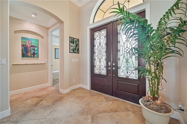 foyer featuring french doors and ornamental molding