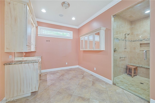 interior space featuring vanity, crown molding, and tiled shower