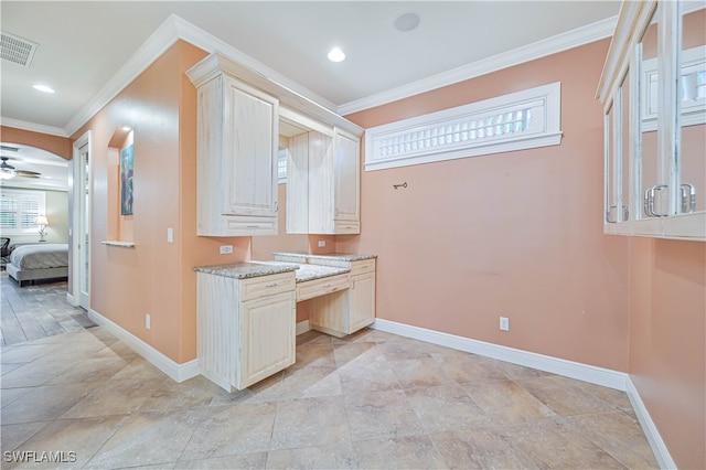 interior space with crown molding, light stone countertops, and ceiling fan