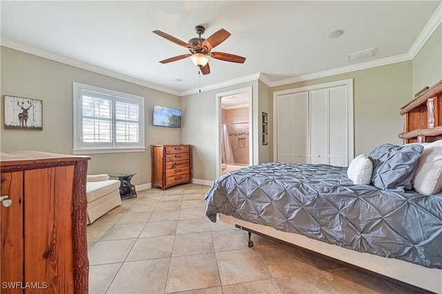 tiled bedroom featuring crown molding, ceiling fan, a closet, and ensuite bath