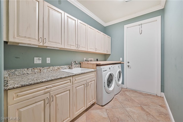 laundry area with sink, light tile patterned flooring, crown molding, cabinets, and washer and dryer