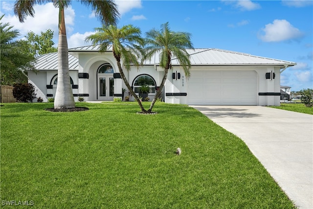 view of front of house featuring concrete driveway, metal roof, a front lawn, and stucco siding