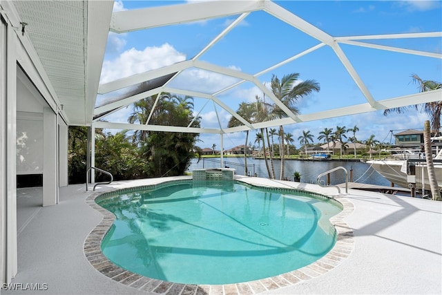 view of pool with a lanai, a patio area, and a water view