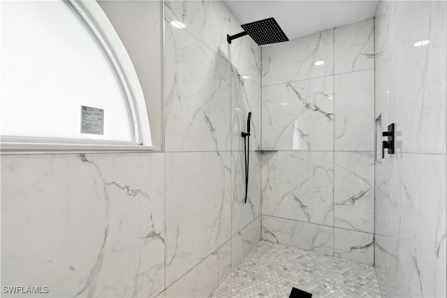 bathroom with a tile shower