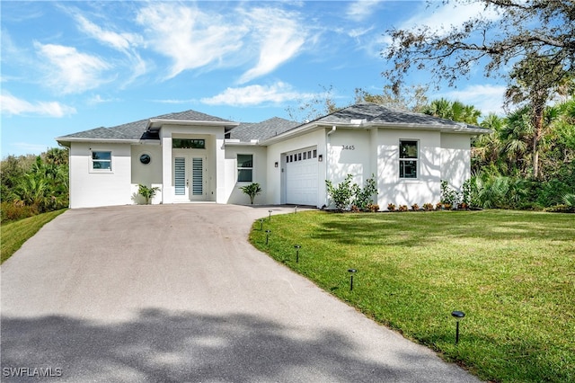 view of front of home featuring a front lawn and a garage