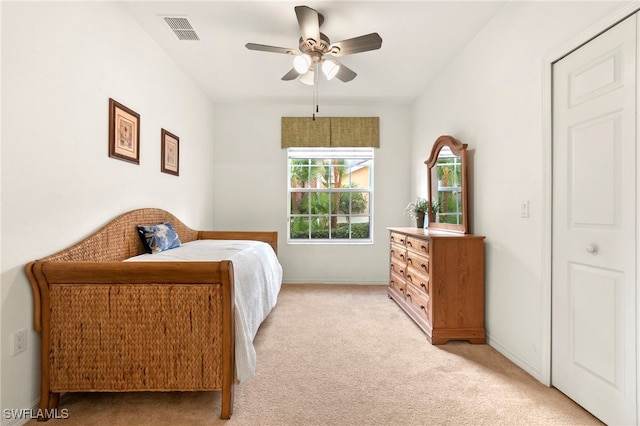 carpeted bedroom featuring ceiling fan and a closet