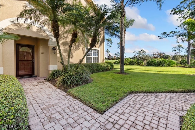 entrance to property with a lawn