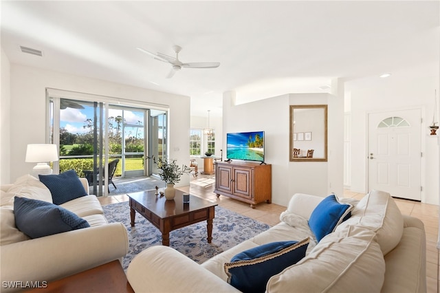 tiled living room featuring ceiling fan