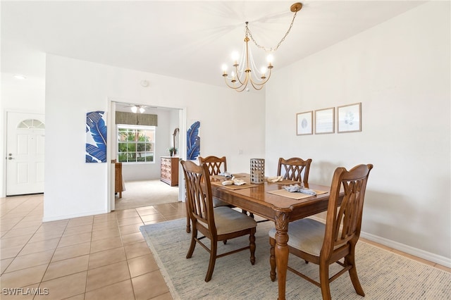 dining space with an inviting chandelier and light tile patterned floors