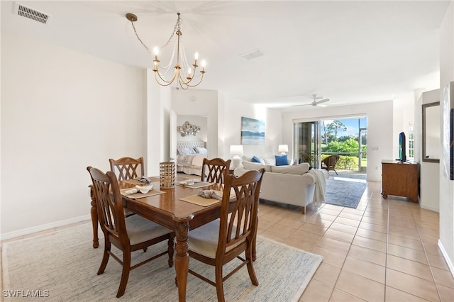 dining area with ceiling fan with notable chandelier and light tile patterned flooring