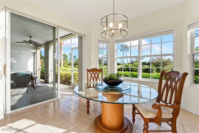 sunroom with ceiling fan with notable chandelier