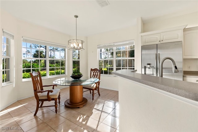 sunroom with an inviting chandelier