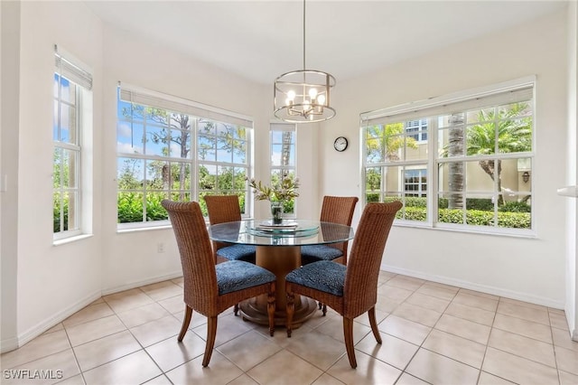 20301 E Calice Ct Unit 2002, Estero, FL 33928 - dining area featuring light tile patterned floors, baseboards, and an inviting chandelier