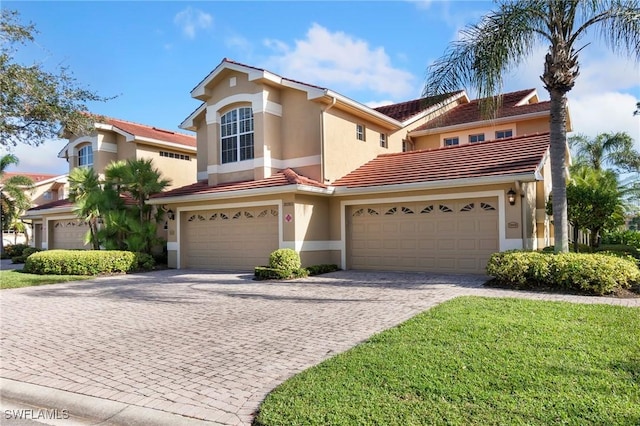 20301 E Calice Ct Unit 2002, Estero, FL 33928 - mediterranean / spanish-style home with stucco siding, a tiled roof, a garage, and decorative driveway