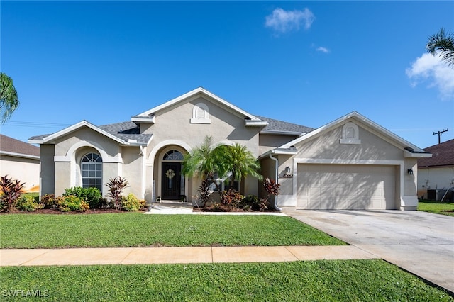 view of front of property featuring a garage and a front lawn