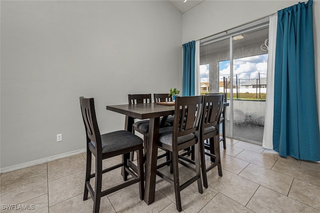 dining space featuring light tile patterned floors