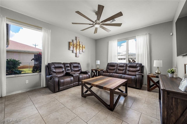 tiled living room featuring a healthy amount of sunlight and ceiling fan