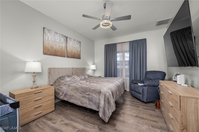 bedroom featuring ceiling fan and dark hardwood / wood-style floors