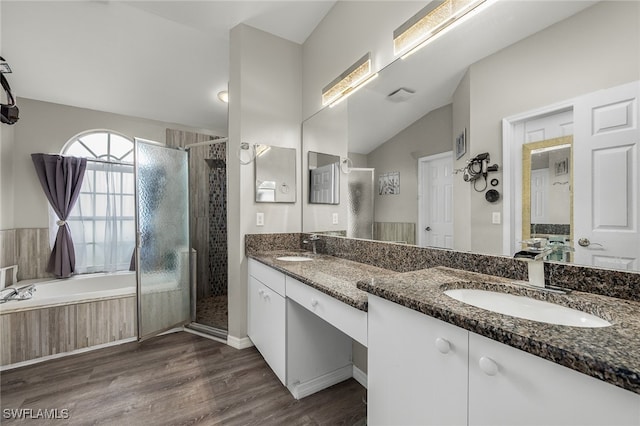 bathroom with vanity, lofted ceiling, shower with separate bathtub, and wood-type flooring