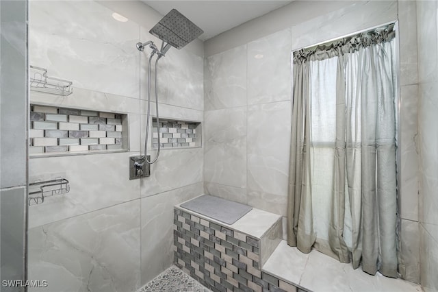 bathroom featuring tile walls and tiled shower