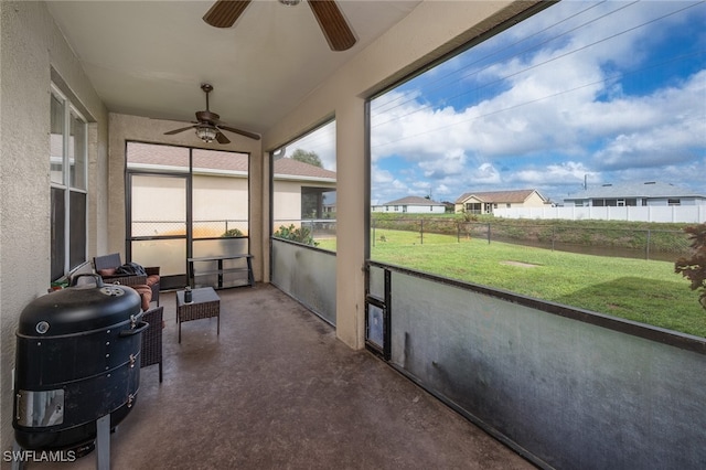 sunroom / solarium featuring ceiling fan