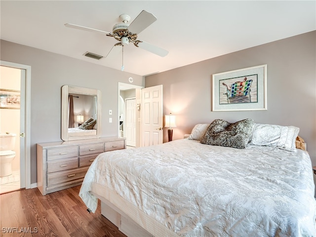 bedroom featuring connected bathroom, ceiling fan, and light hardwood / wood-style flooring